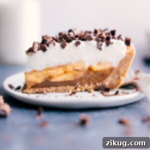 A beautifully presented whole Banoffee Pie, expertly decorated with chocolate shavings, ready to be sliced and served.