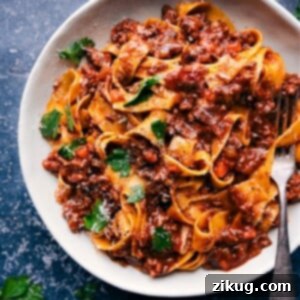 Slow-Cooked Ragu Perfection 2 A delicious Ragu sauce served with wide pasta and fresh Parmesan.