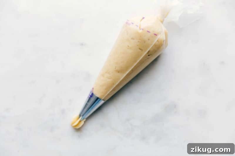 Churro Dough in Piping Bag - Ready to Create Delicious Treats Churro dough inside a pastry piping bag, ready for frying.