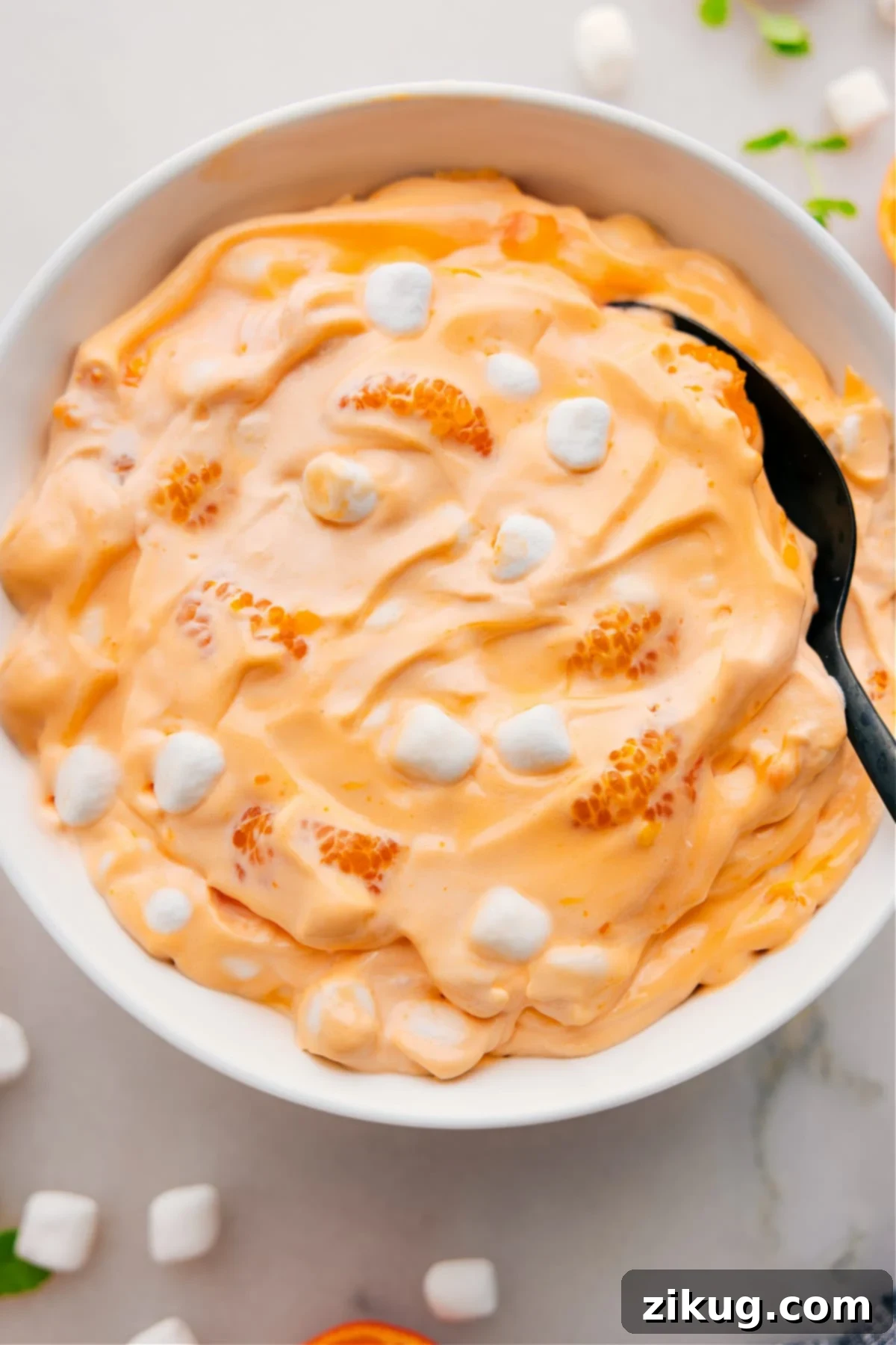 Orange Fluff Salad in a large bowl, garnished with extra mandarin orange segments and mini marshmallows.