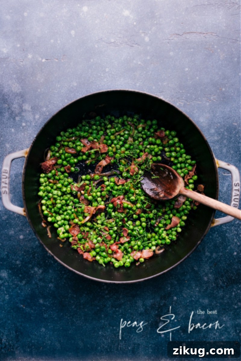 The ultimate Frozen Peas recipe featuring crisp bacon, caramelized shallots, and savory garlic. A quick and easy side dish perfect for any meal. #frozenpeas #bacon #shallots #garlic #sidedish #easyrecipe Overhead image of a bowl of gourmet frozen peas recipe with bacon, shallots, and garlic