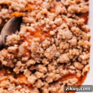 A perfectly baked sweet potato casserole with golden streusel topping, ready to be served, capturing its delicious texture.