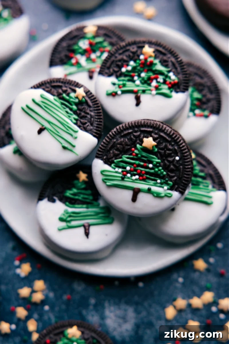 Overhead image of a platter of colorful Christmas Oreos, showcasing all four designs: Christmas trees, melted snowmen, Rudolph, and festive ornaments.