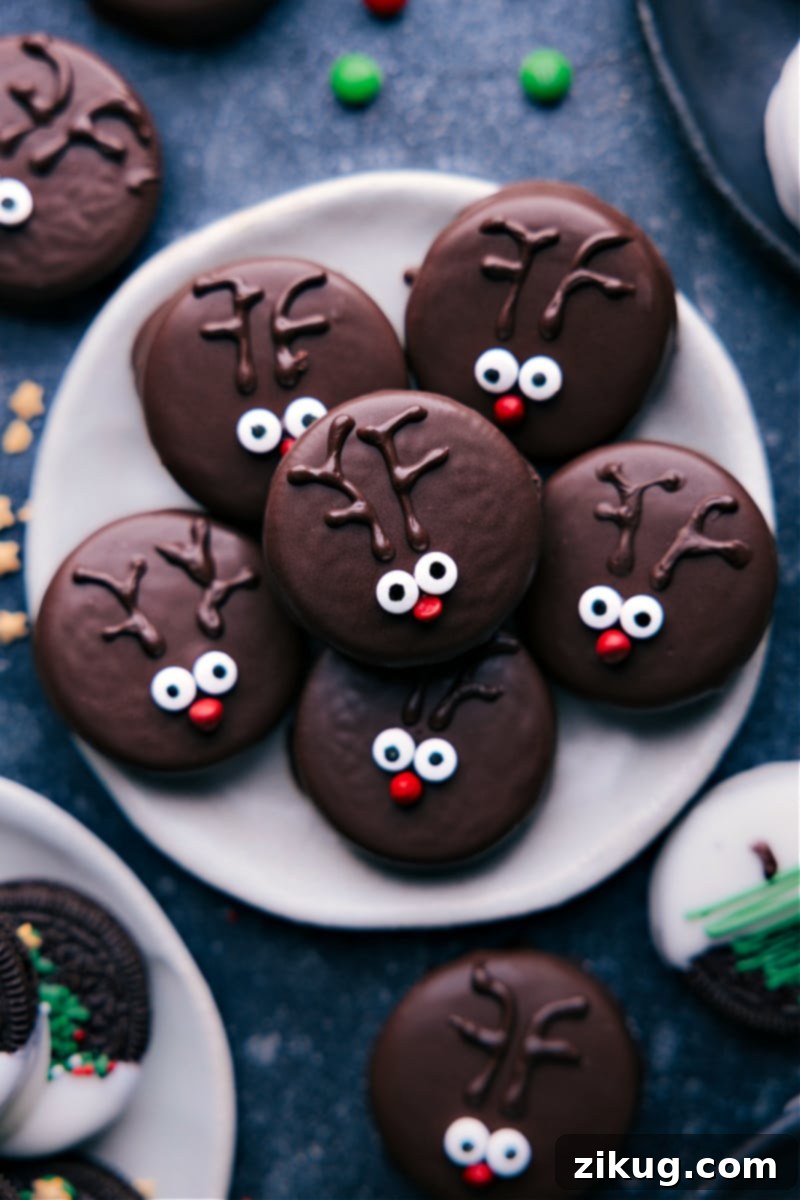 Up-close overhead image of Rudolph the Red-Nosed Reindeer Christmas Oreos, showing the chocolate antlers, candy eyes, and red nose.