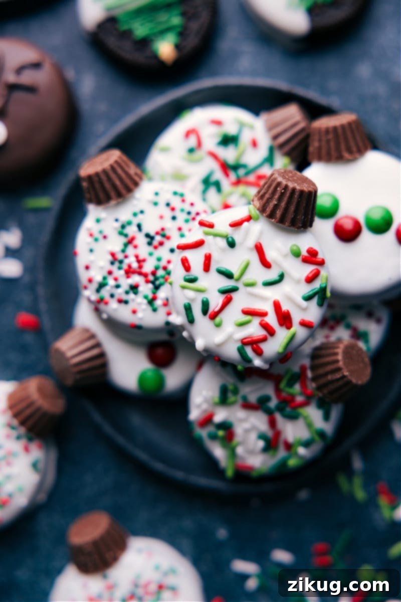 Up-close overhead image of a variety of decorated Christmas Oreos on a platter, ready for holiday serving.