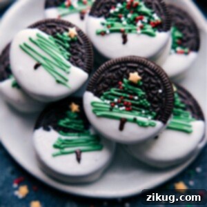 A festive platter of all four Christmas Oreo designs: decorated trees, melted snowmen, Rudolph the Red-Nosed Reindeer, and colorful ornaments.