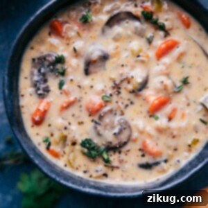 Creamy Mushroom Carrot Farro Soup garnished with fresh herbs.