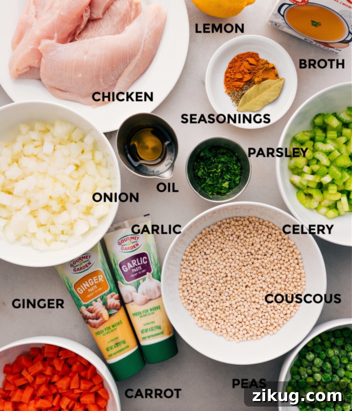 Ingredients for a flavorful couscous soup: fresh vegetables, chicken, pearl couscous, aromatic seasonings, rich broth, and olive oil.
