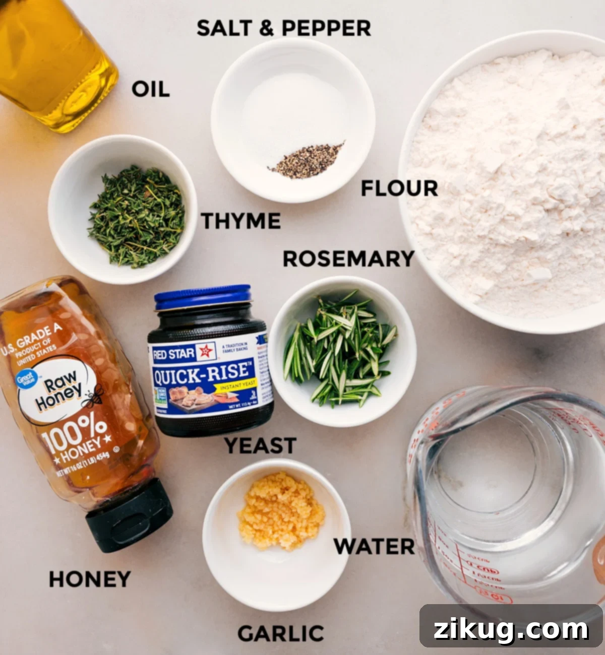 This recipe's ingredients—flour, oil, thyme, rosemary, yeast, water, and honey—are prepped and ready for easy assembly.