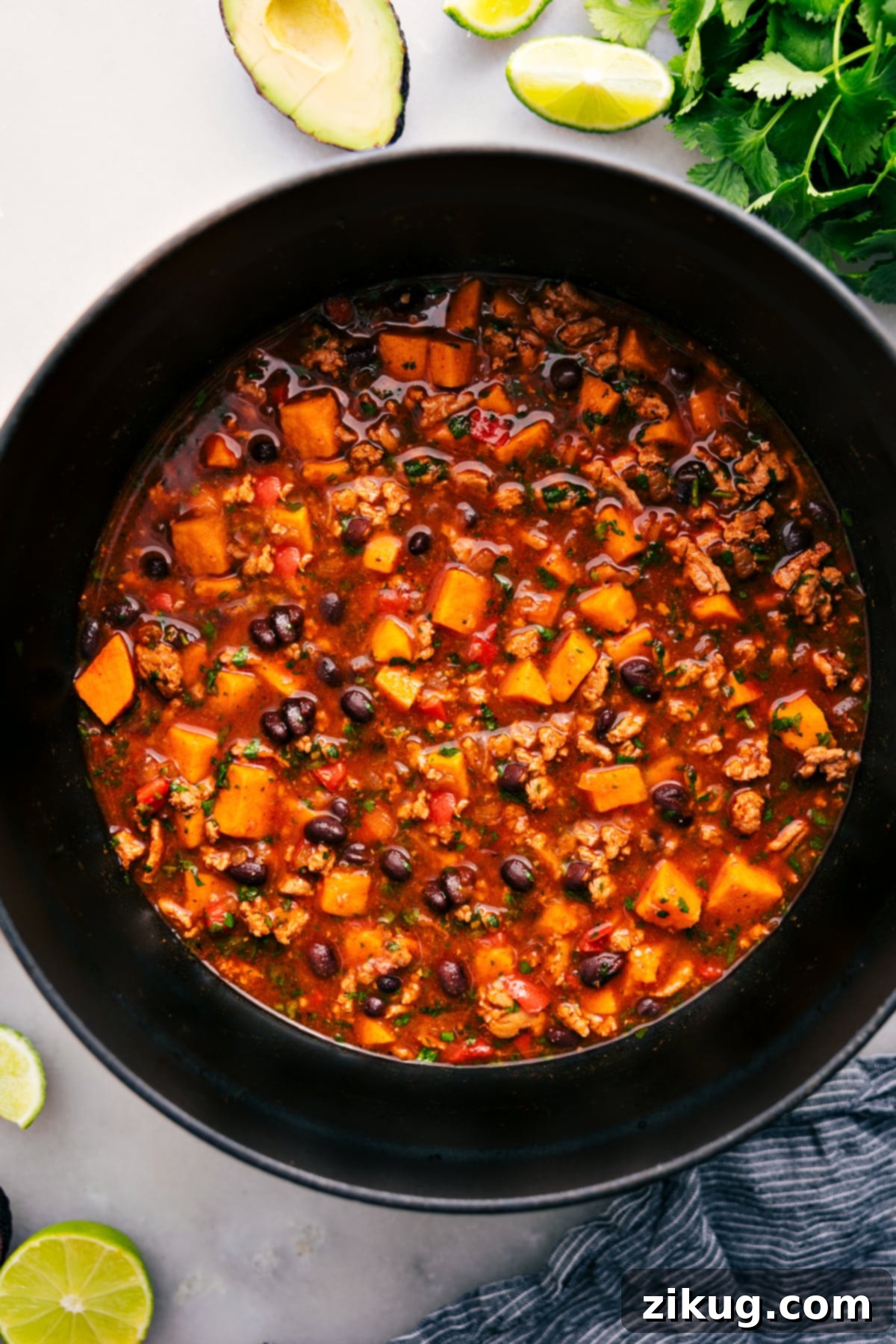 A large pot of steaming Beef Enchilada Soup, ready to be served, showcasing its vibrant color and hearty texture.