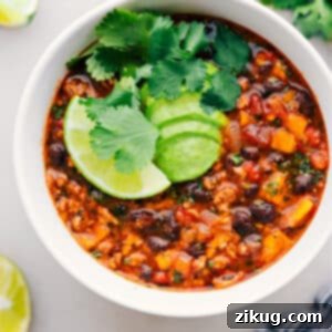 A delicious bowl of Beef Enchilada Soup with fresh toppings.