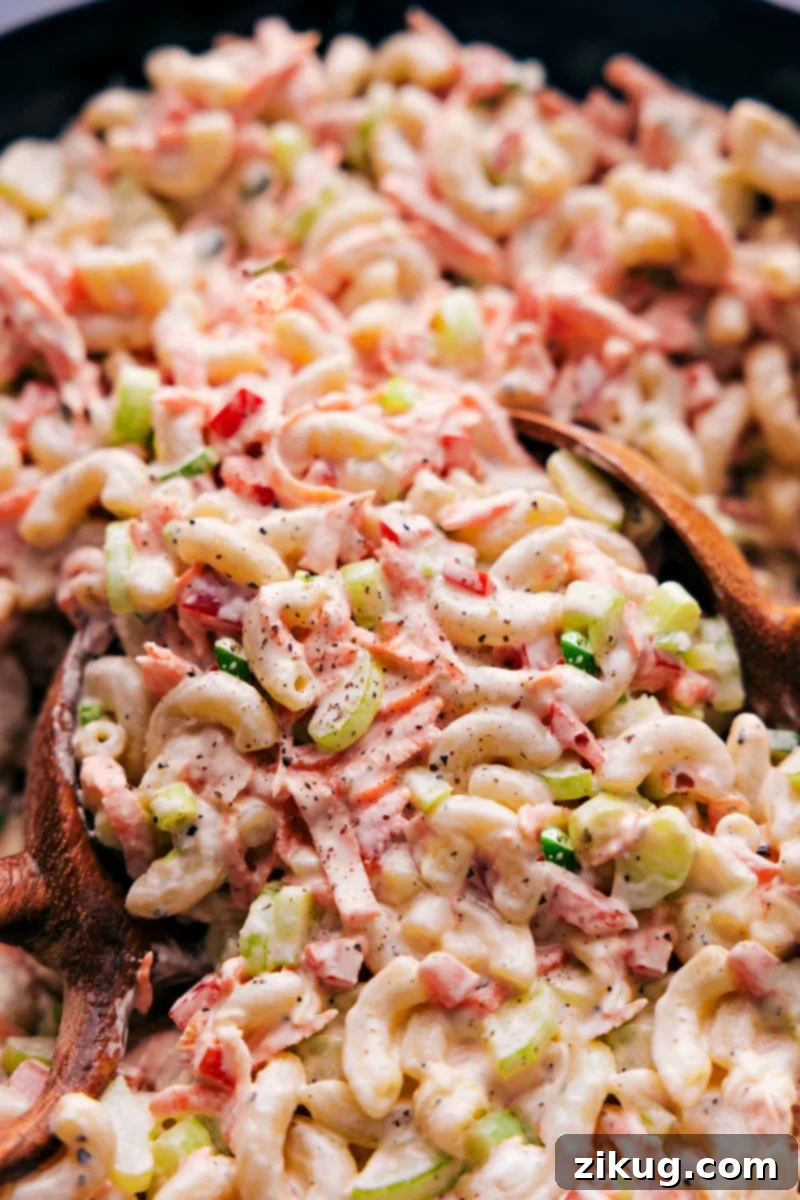 Vibrant Macaroni Salad ready to be served, showcasing its creamy texture and fresh ingredients.