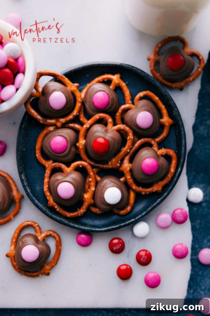 A festive plate of Valentine's Pretzels adorned with red and pink M&M's, ready for sharing.