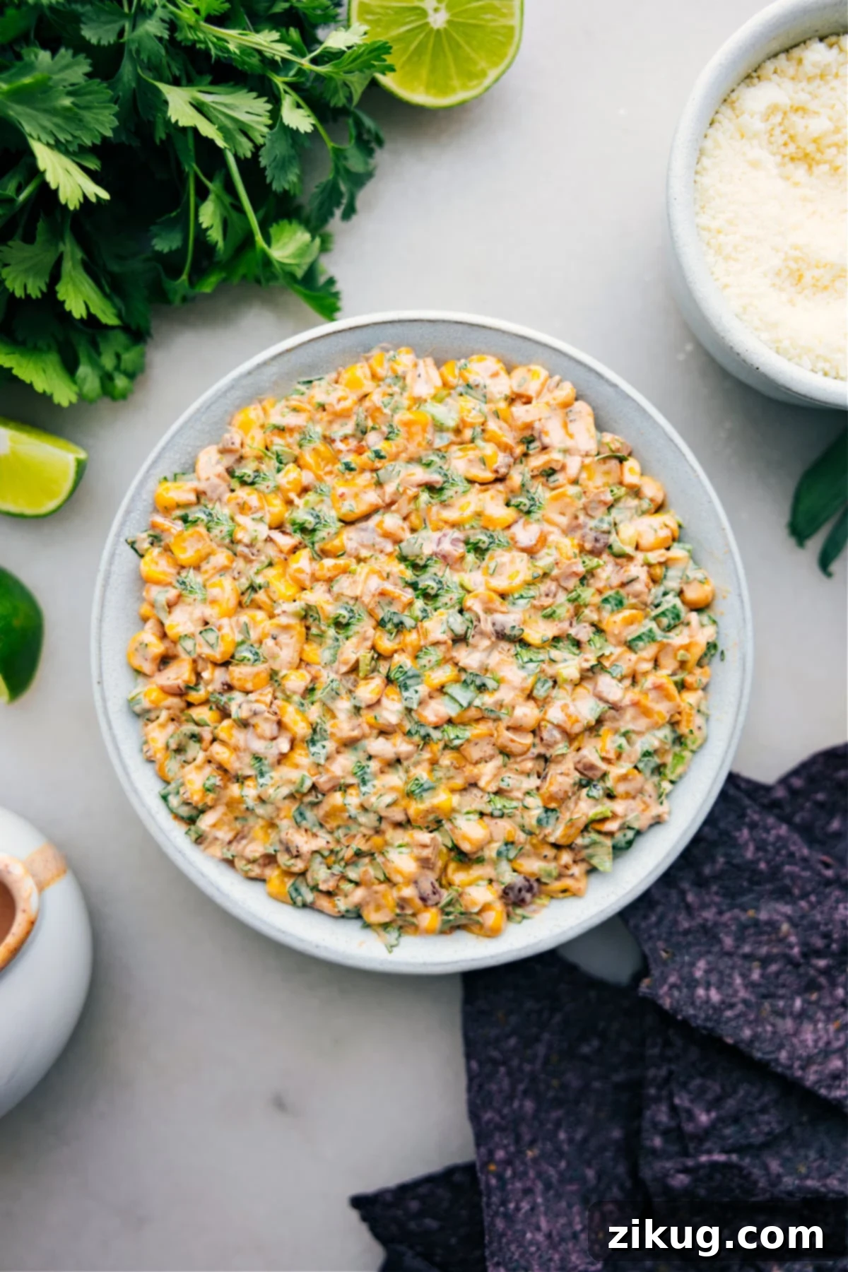 Mexican Street Corn Dip in a bowl with chips ready to be enjoyed.