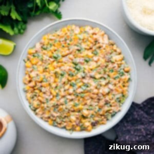 Mexican Street Corn Dip in a bowl with chips ready to be enjoyed.