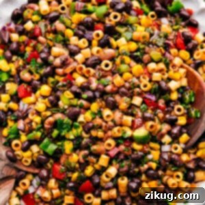 Top-down shot of a bowl of Cowboy Caviar Pasta Salad with an appetizing mix of ingredients.
