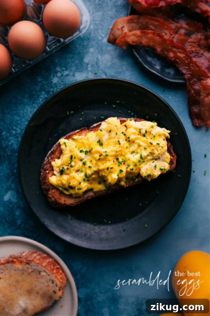 The Ultimate Scrambled Eggs Recipe for a Creamy, Custardy Breakfast Overhead image of Scrambled Eggs perfectly cooked and ready to serve