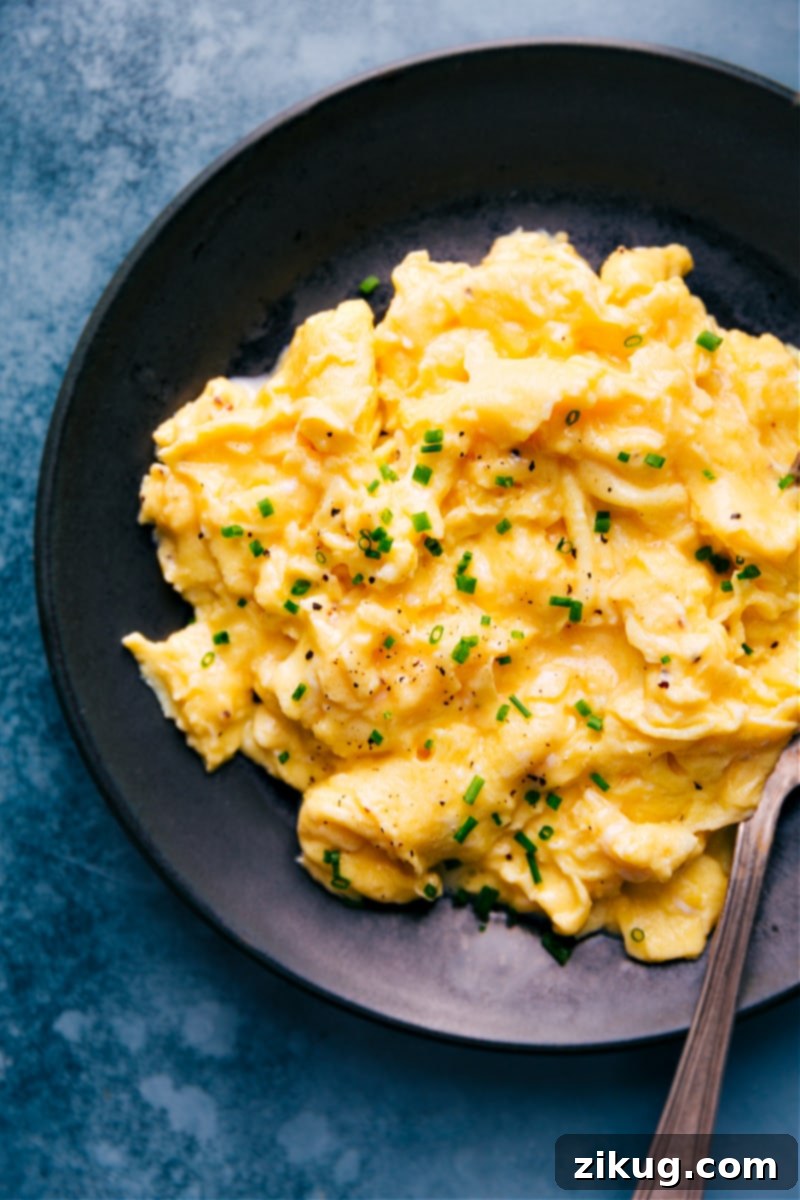 Delicious, creamy scrambled eggs garnished with fresh chives Up-close overhead image of the delicious, creamy scrambled eggs ready to eat