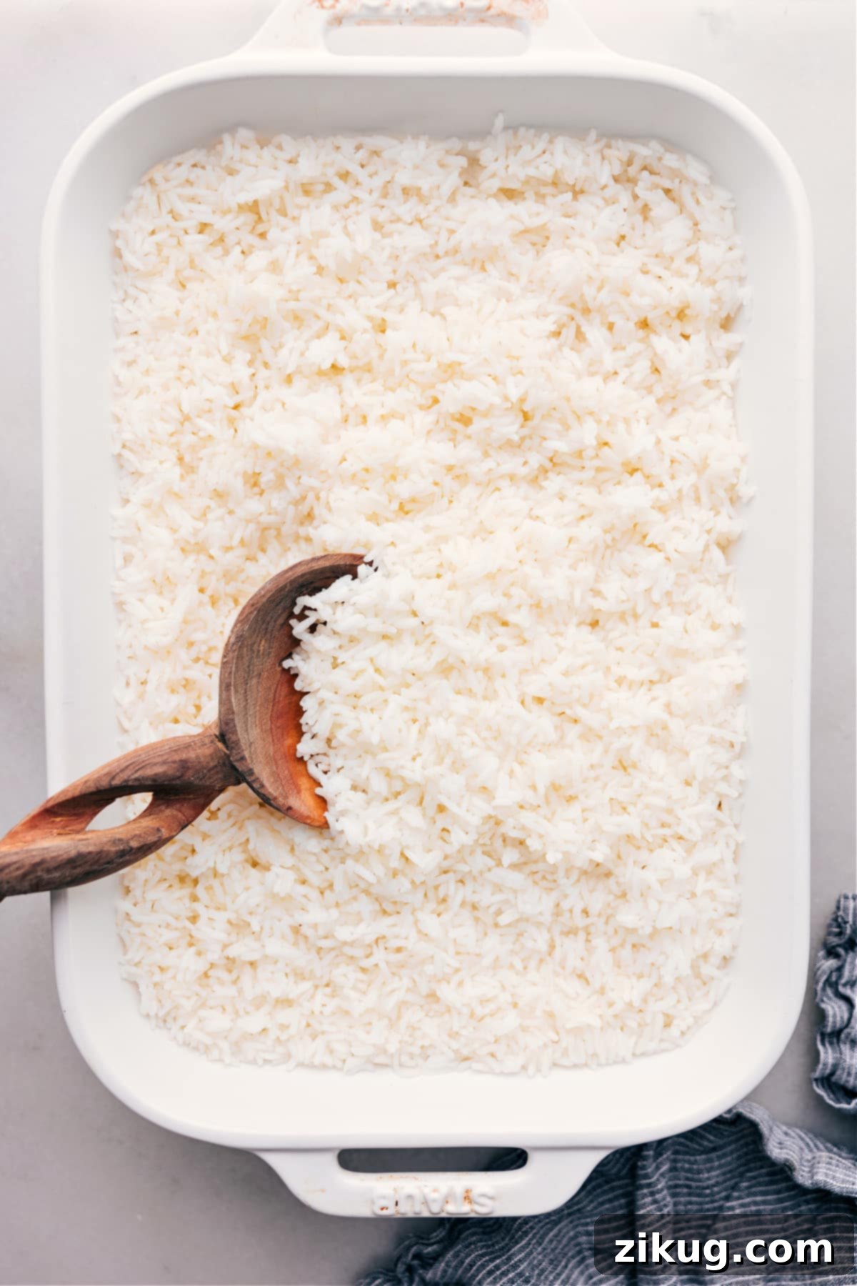 Perfectly cooked, fluffy white rice fresh out of the oven, ready to be served in a ceramic dish