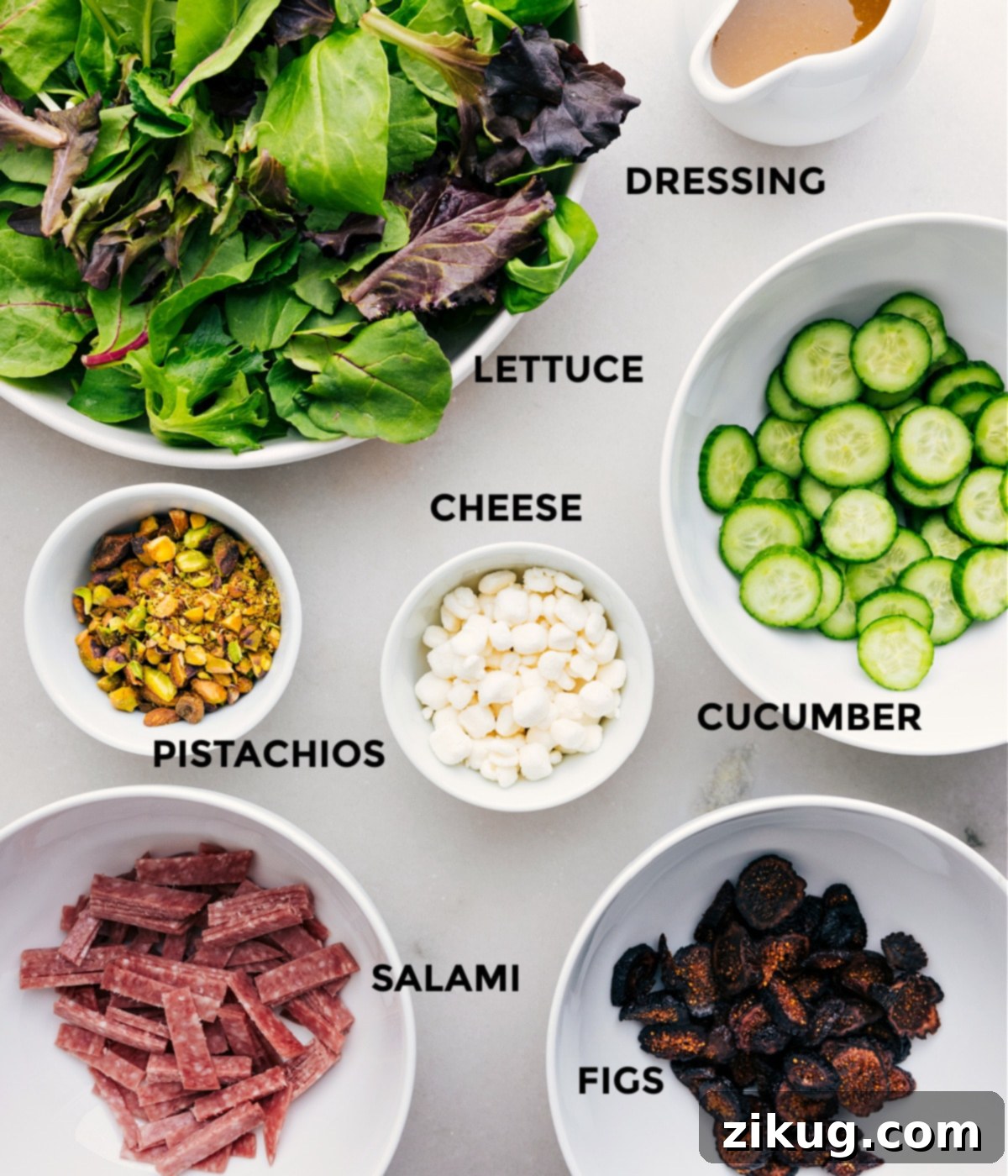 Ingredients In Arugula Salad Recipe All the ingredients in this recipe—greens, dressing, cucumbers, cheese, pistachios, salami, and figs—are prepped for easy assembly.