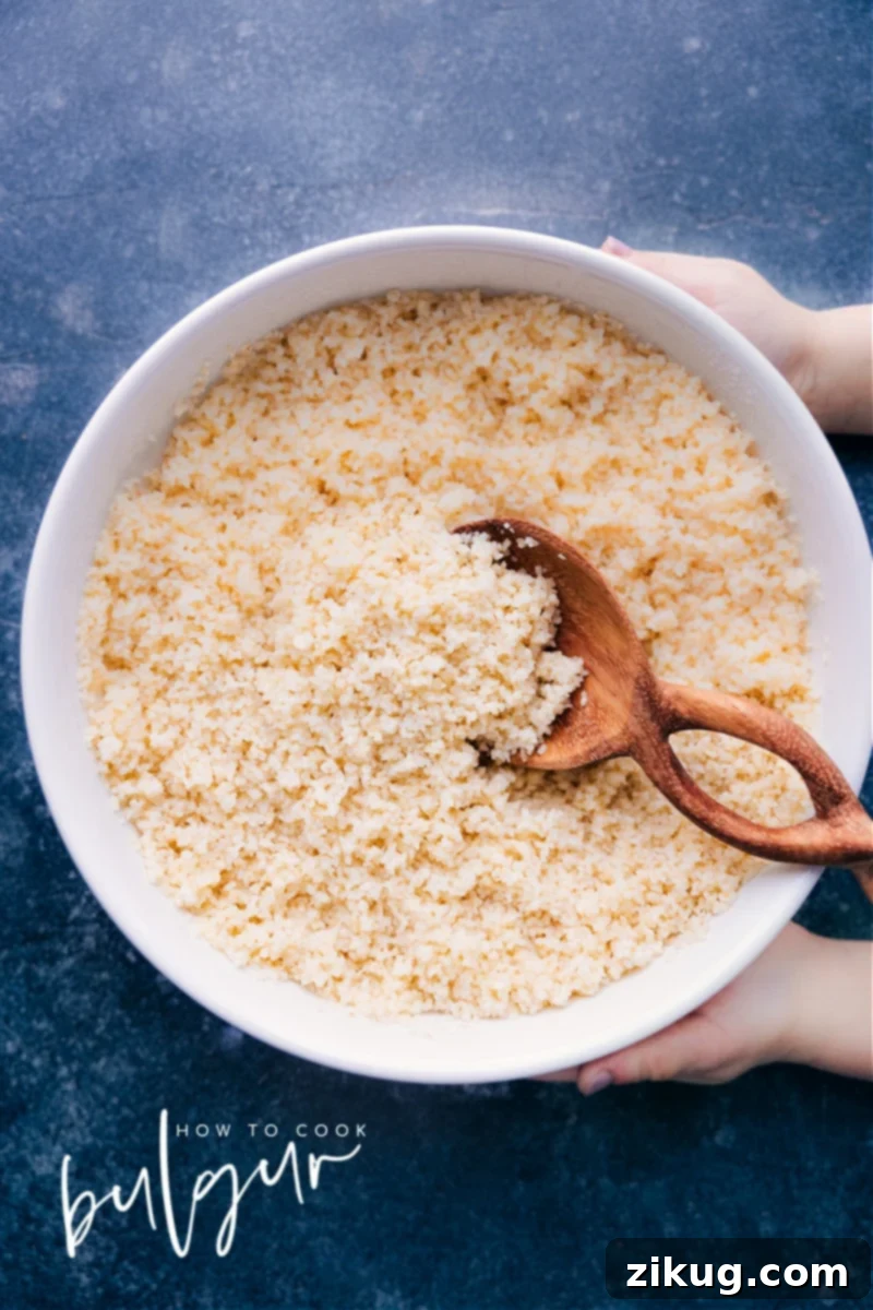 Discover the secret to perfectly fluffy and flavorful bulgur in this guide for How To Cook Bulgur Wheat! Say goodbye to bland and mushy side dishes, and hello to delicious and nutritious. Whether you're a seasoned home cook or new to this versatile grain, this easy-to-follow recipe is the perfect starting point. Not only is bulgur quick and simple to make, but it's also packed with health benefits, making it a great addition to any meal. Overhead image of How to Cook Bulgur Wheat, showcasing perfectly fluffy grains in a bowl