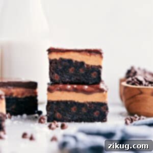 Buckeye Brownies, showcasing the three distinct layers: fudgy chocolate brownie, creamy peanut butter, and smooth chocolate topping.