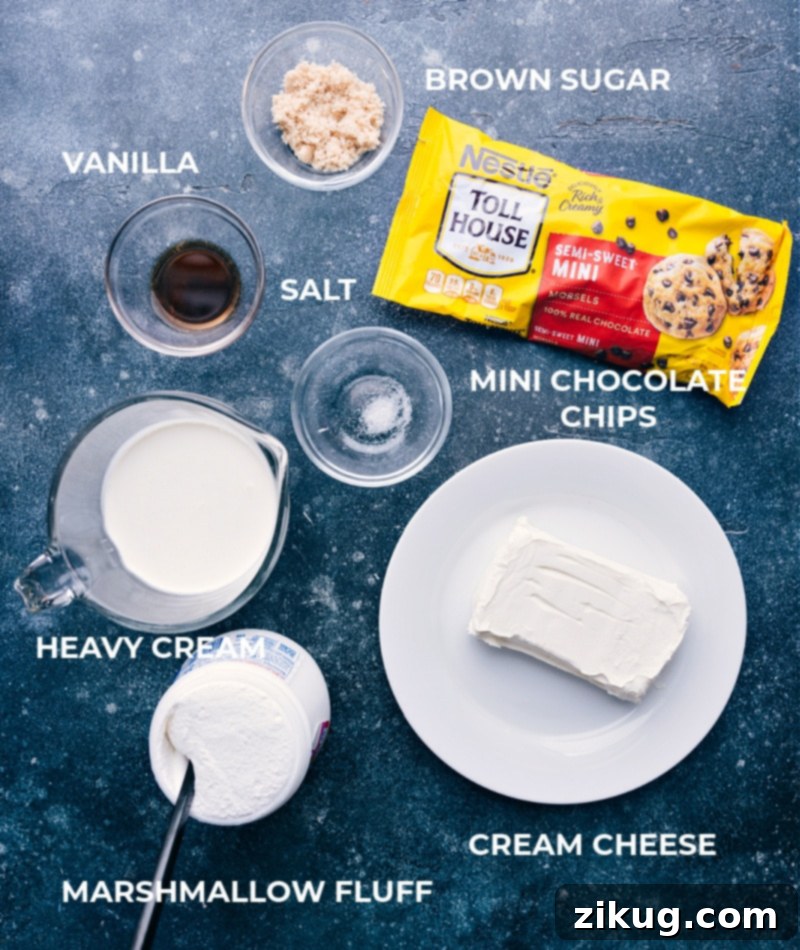 A vibrant display of all the essential ingredients for Chocolate Chip Dip, including a block of cream cheese, vanilla extract, brown sugar, salt, marshmallow fluff, heavy cream, and a bag of mini chocolate chips, meticulously prepped and ready for mixing.