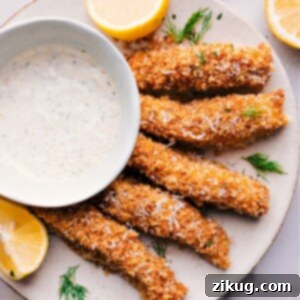 Crispy homemade fish sticks with lemon and tartar sauce.