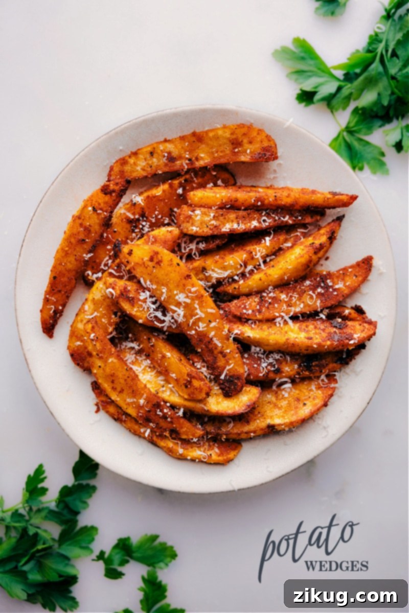 Crispy golden potato wedges seasoned with savory herbs, perfectly arranged on a pristine white plate, ready to be enjoyed with a delicious dipping sauce.