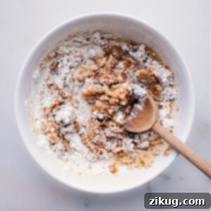 Mixing melted butter with dry streusel ingredients
