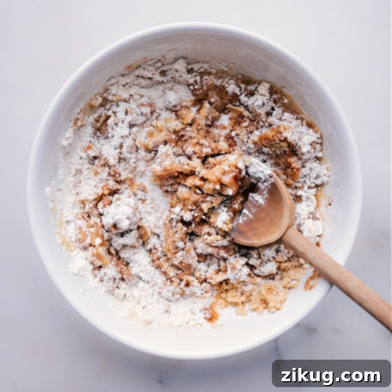 Process shots of how to make streusel, showing all ingredients being mixed together in a bowl until crumbly