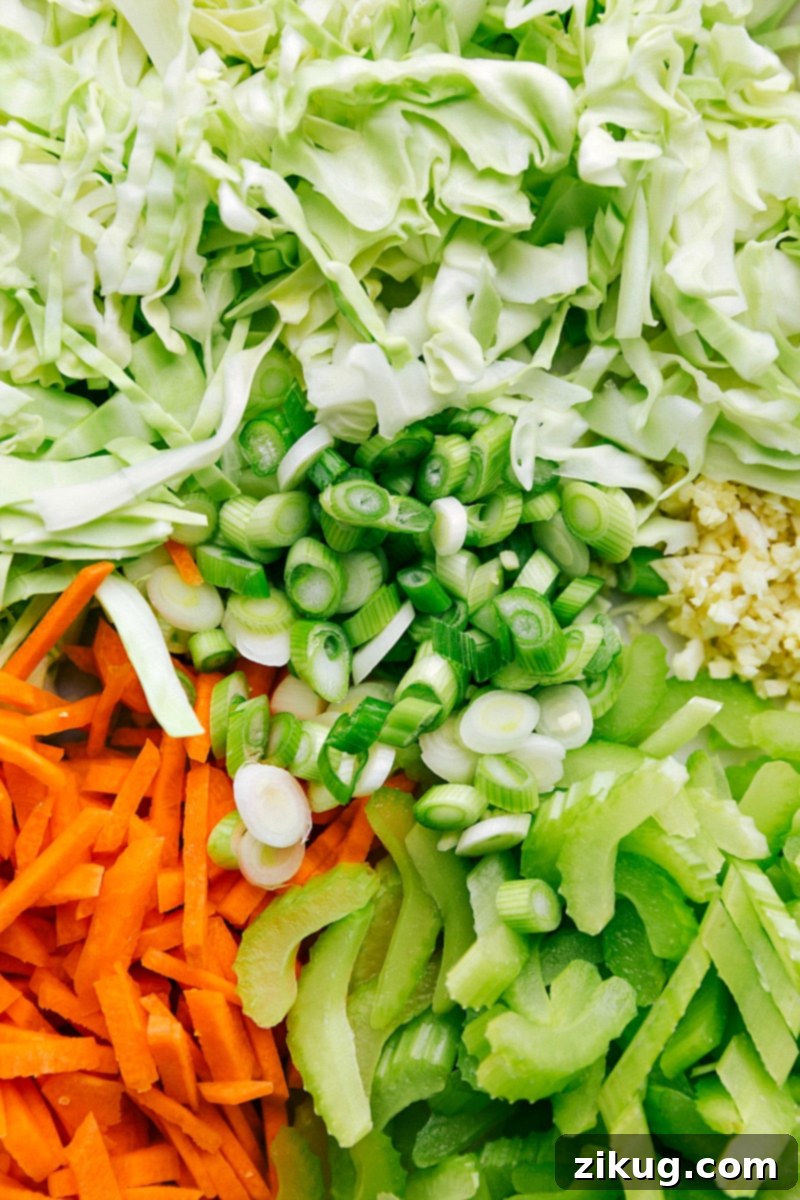 Chopped Veggies for Chicken Chow Mein Freshly chopped vegetables ready to be added to the chicken chow mein, including cilantro, carrots, green onions, and cabbage.