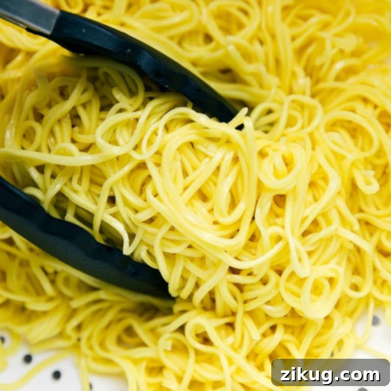 Cooked Pasta for Chicken Chow Mein Cooked pasta ready to be added to the chicken chow mein recipe, perfectly cooked and ready to absorb flavors.