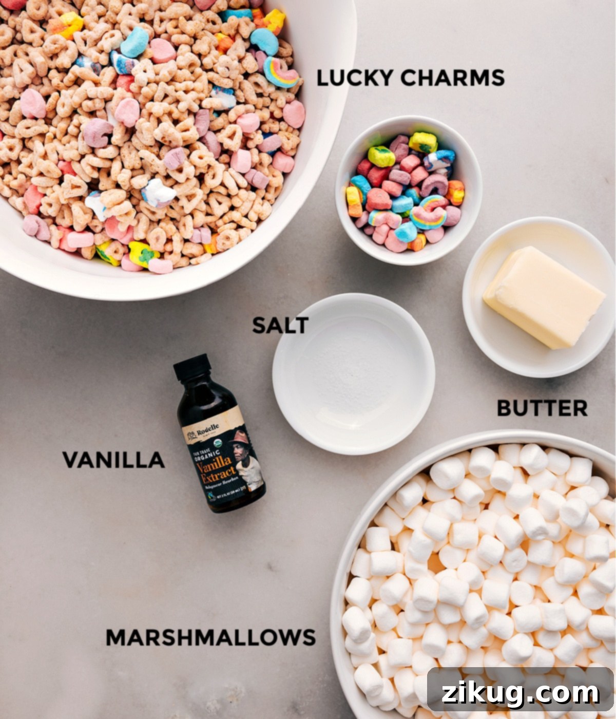All the essential ingredients neatly prepped for easy assembly: Lucky Charms cereal, butter, salt, vanilla extract, and miniature marshmallows.