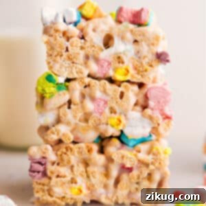 A close-up of a perfectly cut Lucky Charms Bar, showing the colorful cereal and gooey marshmallow texture.