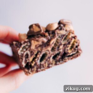 A top-down view of freshly made Muddy Buddy Bars, cut into squares and dusted with powdered sugar, ready for serving.
