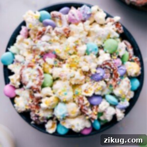 A large bowl filled with delicious Easter Popcorn, featuring white chocolate-coated popcorn, pretzels, and colorful M&M's, ready to be served.