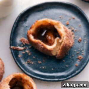 A freshly baked Empty Tomb Roll, gently broken open to reveal its empty, hollow center, dusted with a fine layer of cinnamon sugar.