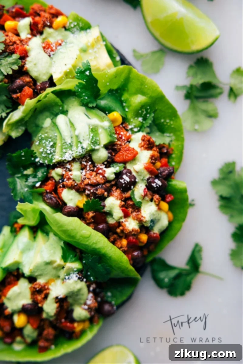 Healthy Turkey Lettuce Wraps: A Quick & Easy Weeknight Dinner Idea A vibrant overhead shot of freshly prepared Turkey Lettuce Wraps, featuring crispy lettuce cups overflowing with a seasoned ground turkey and vegetable mixture, garnished with fresh cilantro and a squeeze of lime. This healthy, easy weeknight dinner is packed with flavor and lean protein.