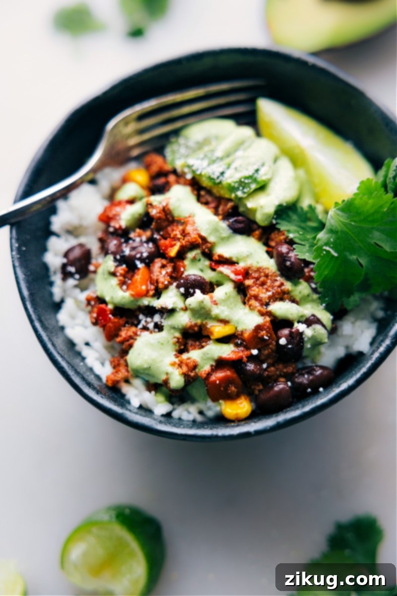 Versatile Turkey Filling Served Over Rice for a Hearty Meal An inviting overhead view of the Turkey Lettuce Wraps filling served in a bowl with rice, demonstrating an alternate serving suggestion for a heartier, comforting meal, garnished with fresh cilantro.