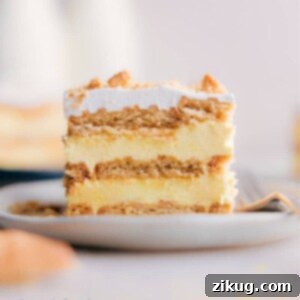 A fully assembled Lemon Icebox Cake with a smooth whipped topping, ready to be chilled.