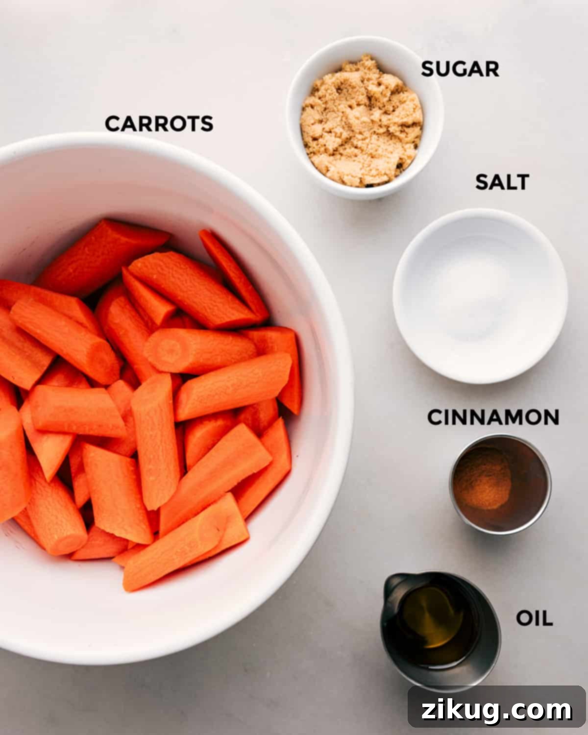 Ingredients for Brown Sugar Roasted Carrots, including fresh carrots, brown sugar, olive oil, cinnamon, salt, and pepper, all neatly prepped and laid out for easy assembly.