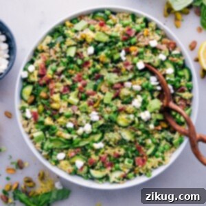 Herbalicious Quinoa Salad in a serving bowl with a small portion scooped out
