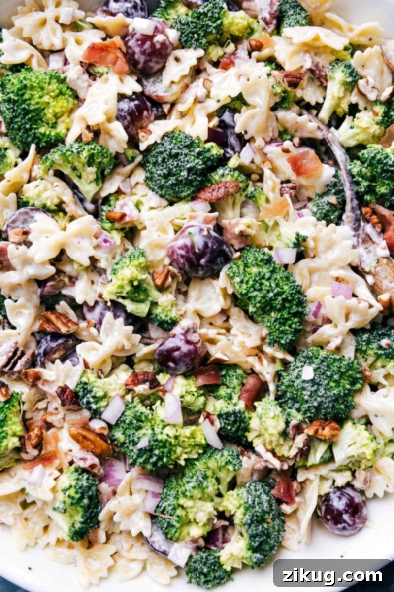 Delicious Broccoli Grape Pasta Salad in a Bowl with Serving Spoon Delicious and healthy side dish in a bowl, ready to be enjoyed.