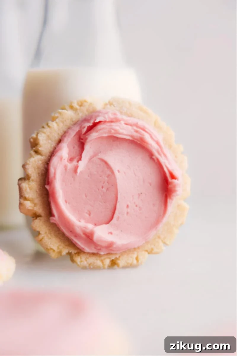 Homemade Swig Sugar Cookies: Soft, Chewy, Thick, and Frosted to Perfection A beautifully frosted Swig Sugar Cookie with its signature indentation, resting on a cooling rack, ready to be savored. The cookie appears thick and invitingly soft.