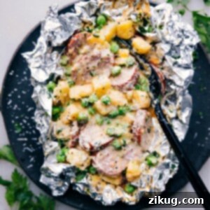 Delicious Creamy Sausage and Potato Foil Packs, garnished with fresh parsley, ready to be enjoyed.