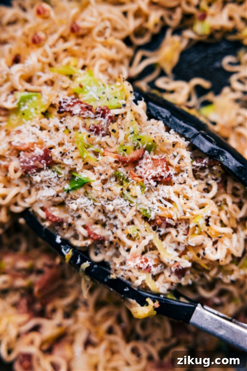 An inviting, close-up overhead image of a bowl of Fried Cabbage Ramen, perfectly garnished and ready to be enjoyed, highlighting the texture of noodles, cabbage, and bacon bits.