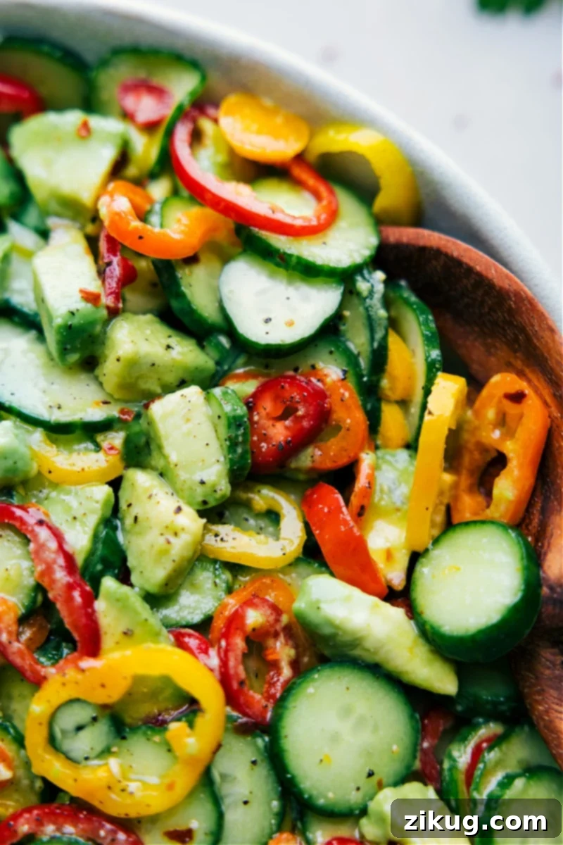 A beautifully presented Cucumber Pepper Salad, glistening with dressing, showcased in a bowl and ready for an enjoyable meal.