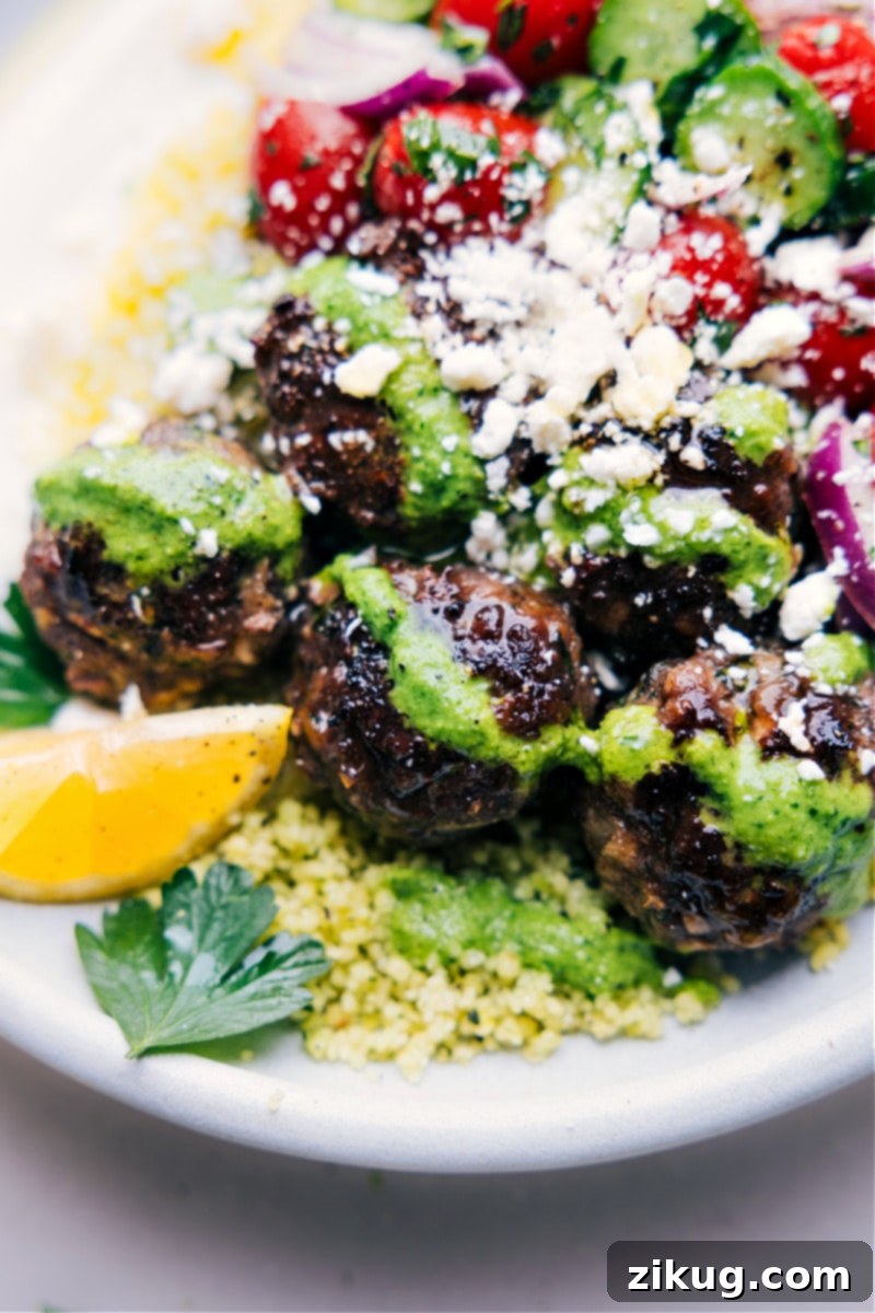 Mediterranean Meatball Bowls 10 Close-up image of a single Greek Meatball Bowl, showcasing the intricate details of the meatballs, couscous, fresh salad, and sauce for an appetizing view.