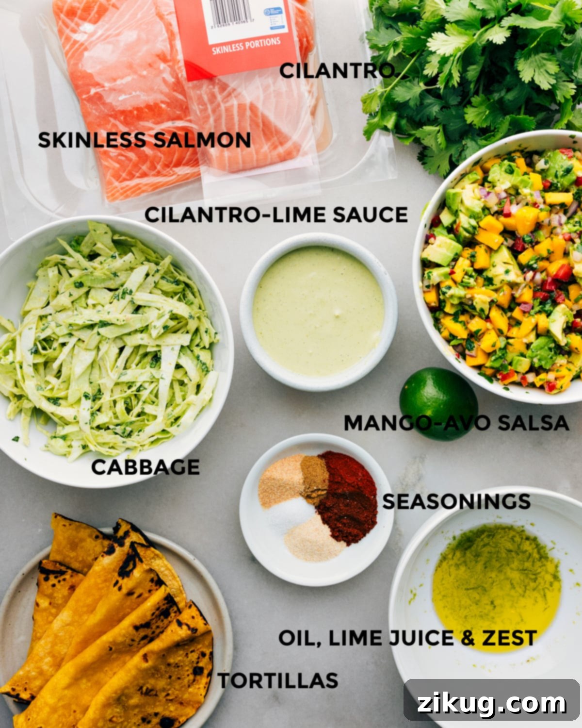 All the vibrant ingredients for Salmon Tacos laid out on a cutting board, ready for preparation.